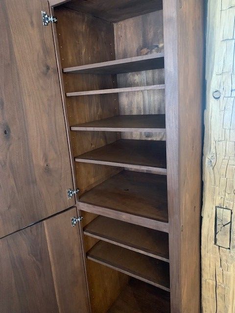 inside of solid wood pantry cabinet.