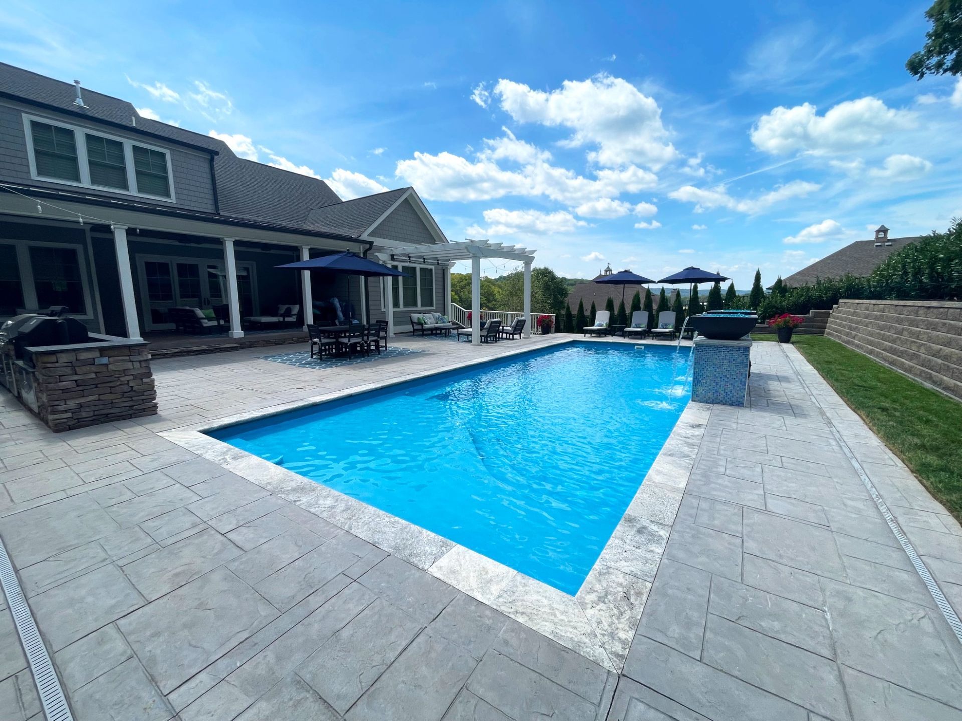 View of 16x40 Aspen pool with spa and fire/water features by Majestic Swim in Eagleville