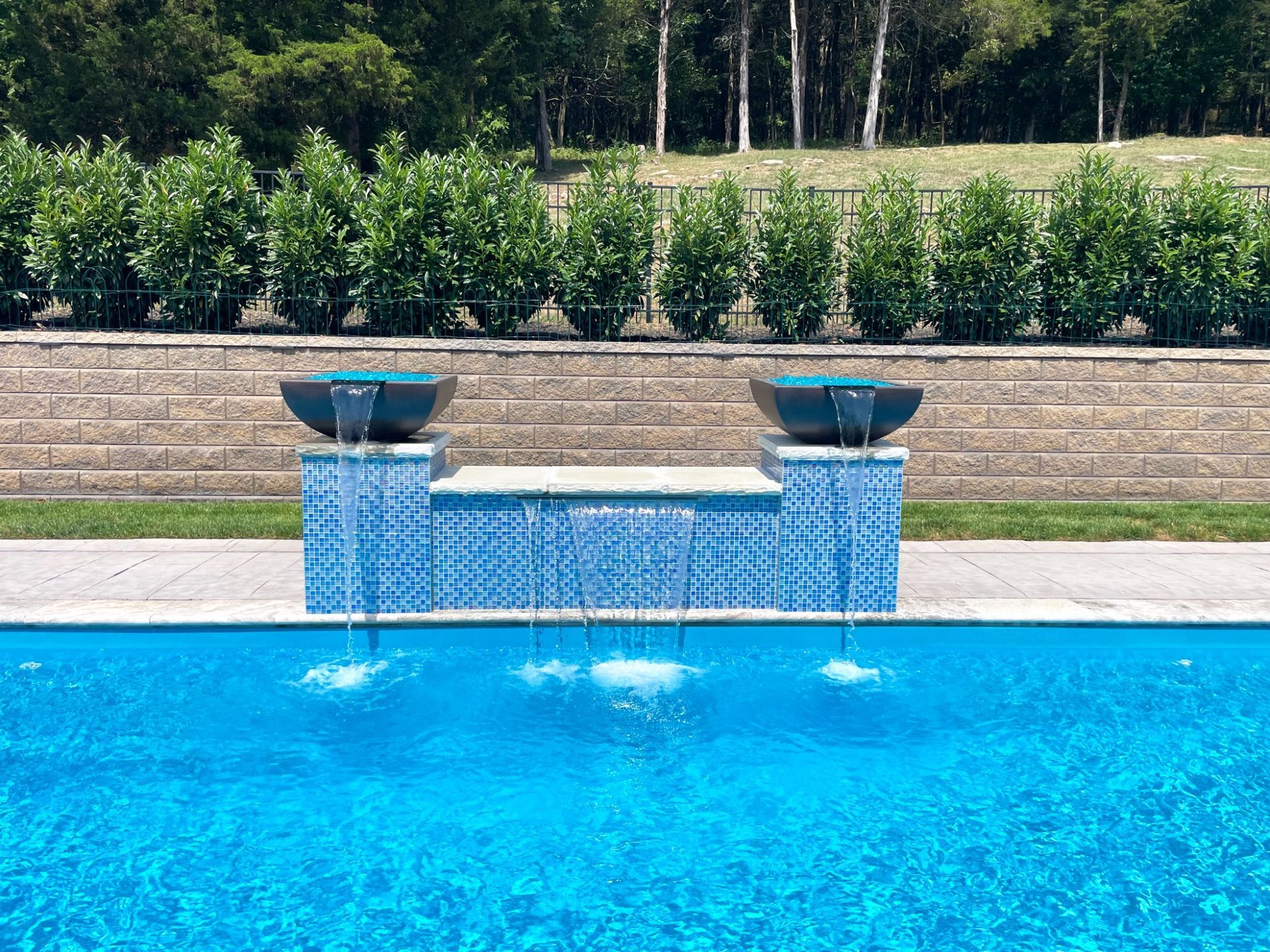 Majestic Swim pool in Eagleville featuring a 9ft spillover spa and landscaping