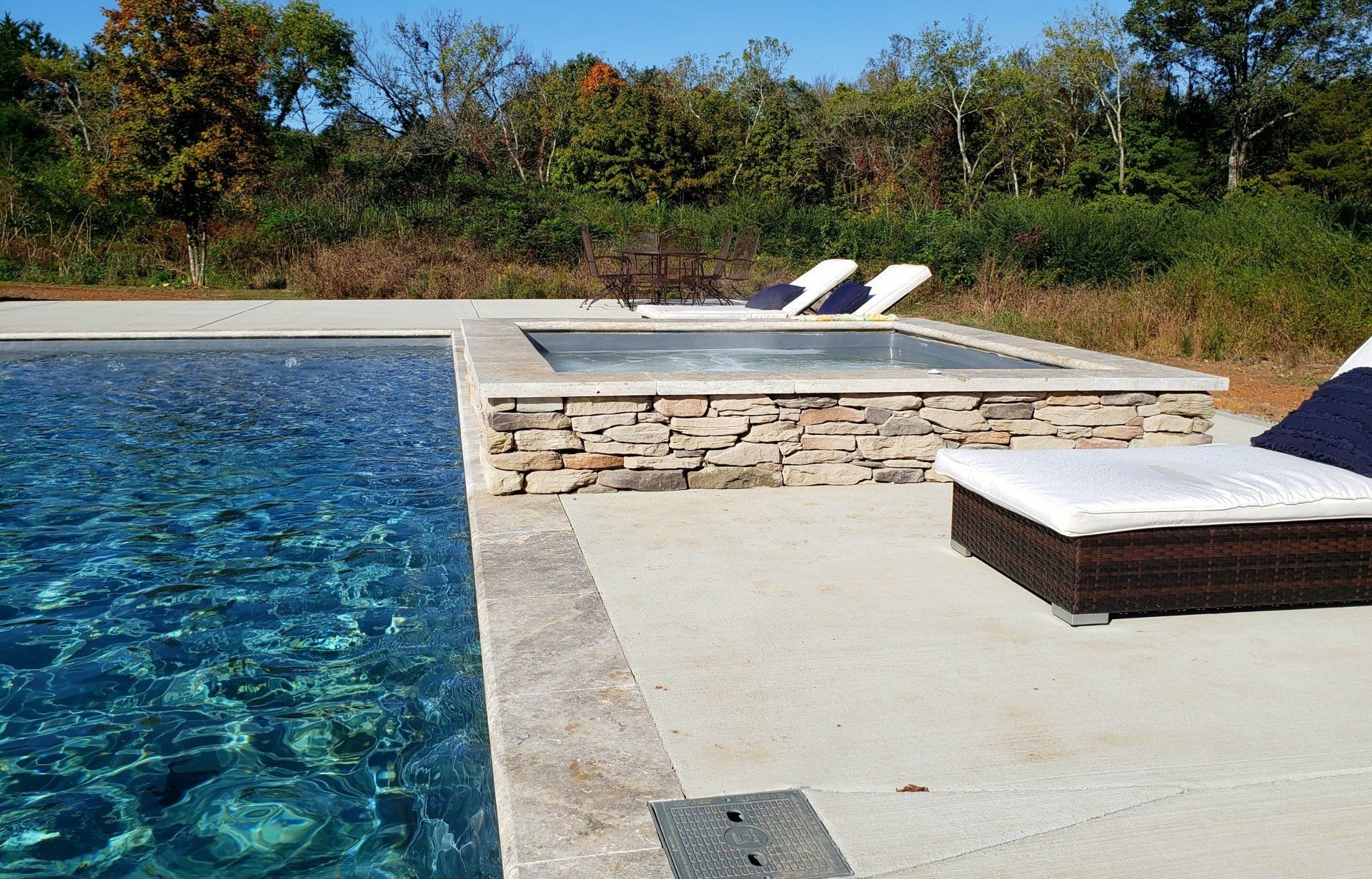 Overhead view of Aspen 16x40 pool with split wet deck and spillover spa in Murfreesboro by Majestic Swim.