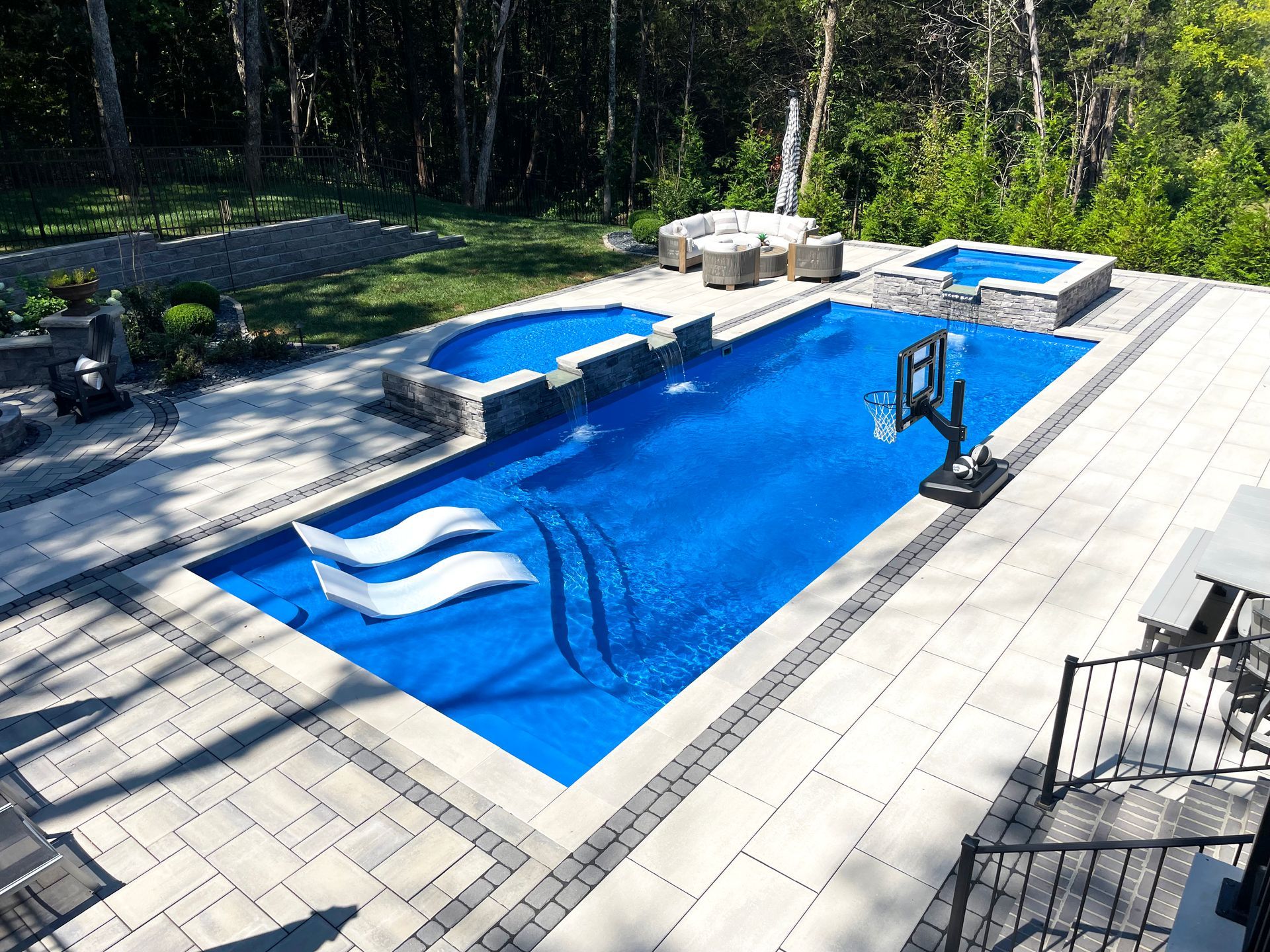 Overhead view of Aspen 16x40 pool with split wet deck and spillover spa in Murfreesboro by Majestic Swim.