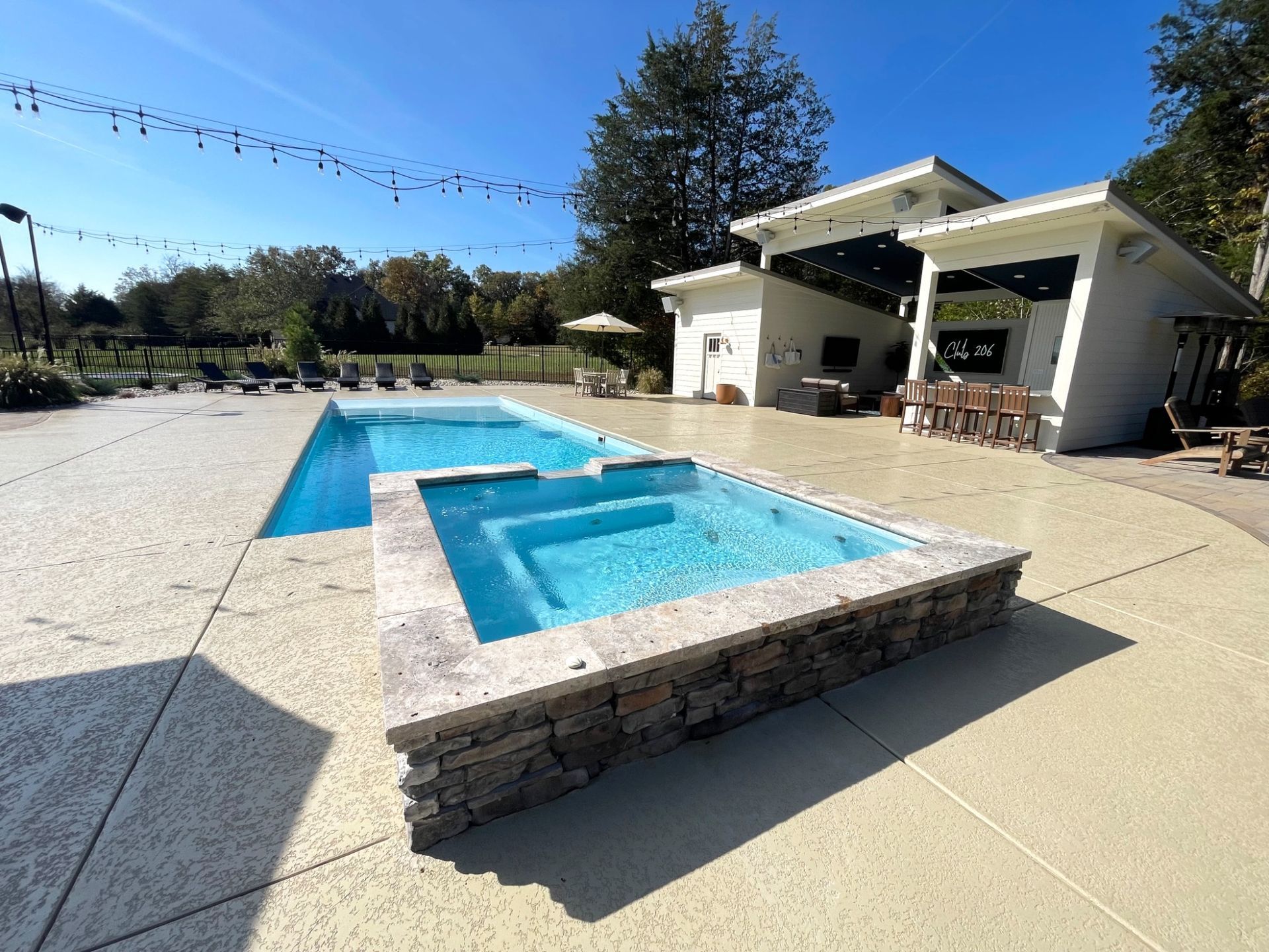 Covered outdoor kitchen and seating area next to Grace pool in Murfreesboro TN