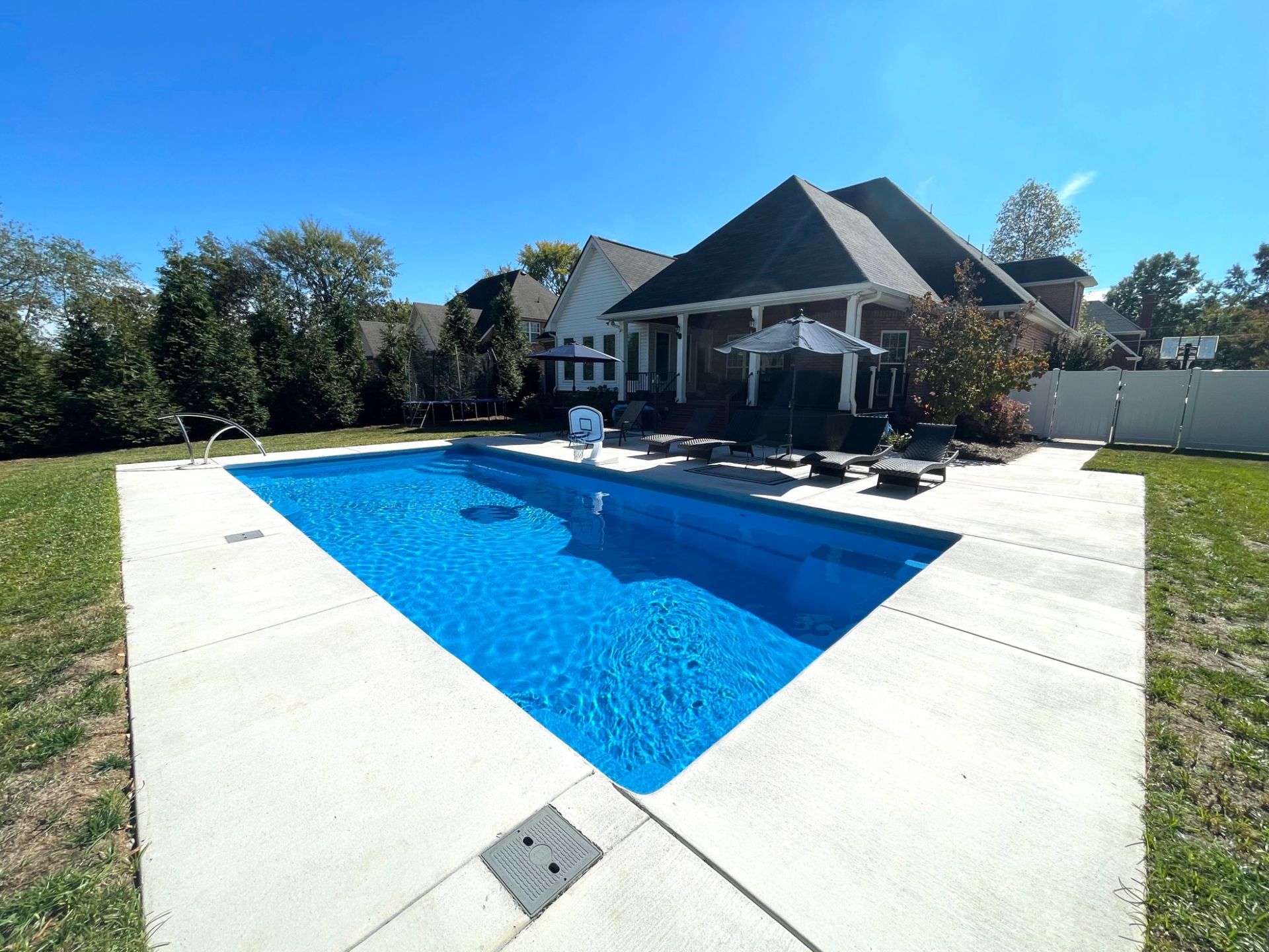 Backyard view of Goliath 16x33 rectangular pool with lounging area in Smyrna TN