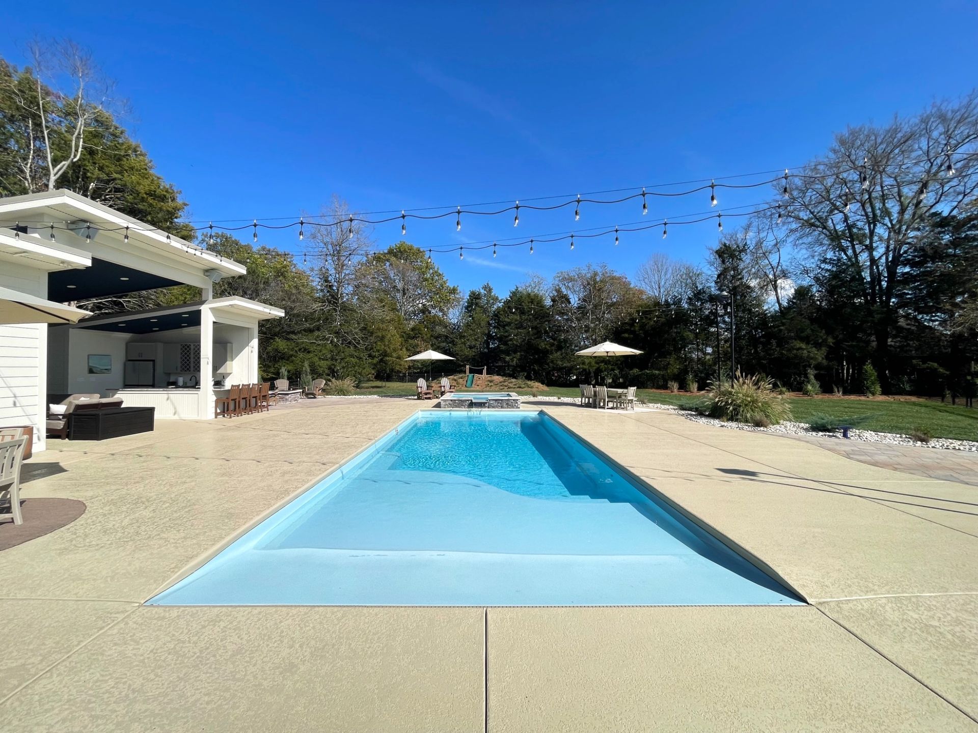 Grace beach entry pool with lounge chairs and patio seating in Murfreesboro TN