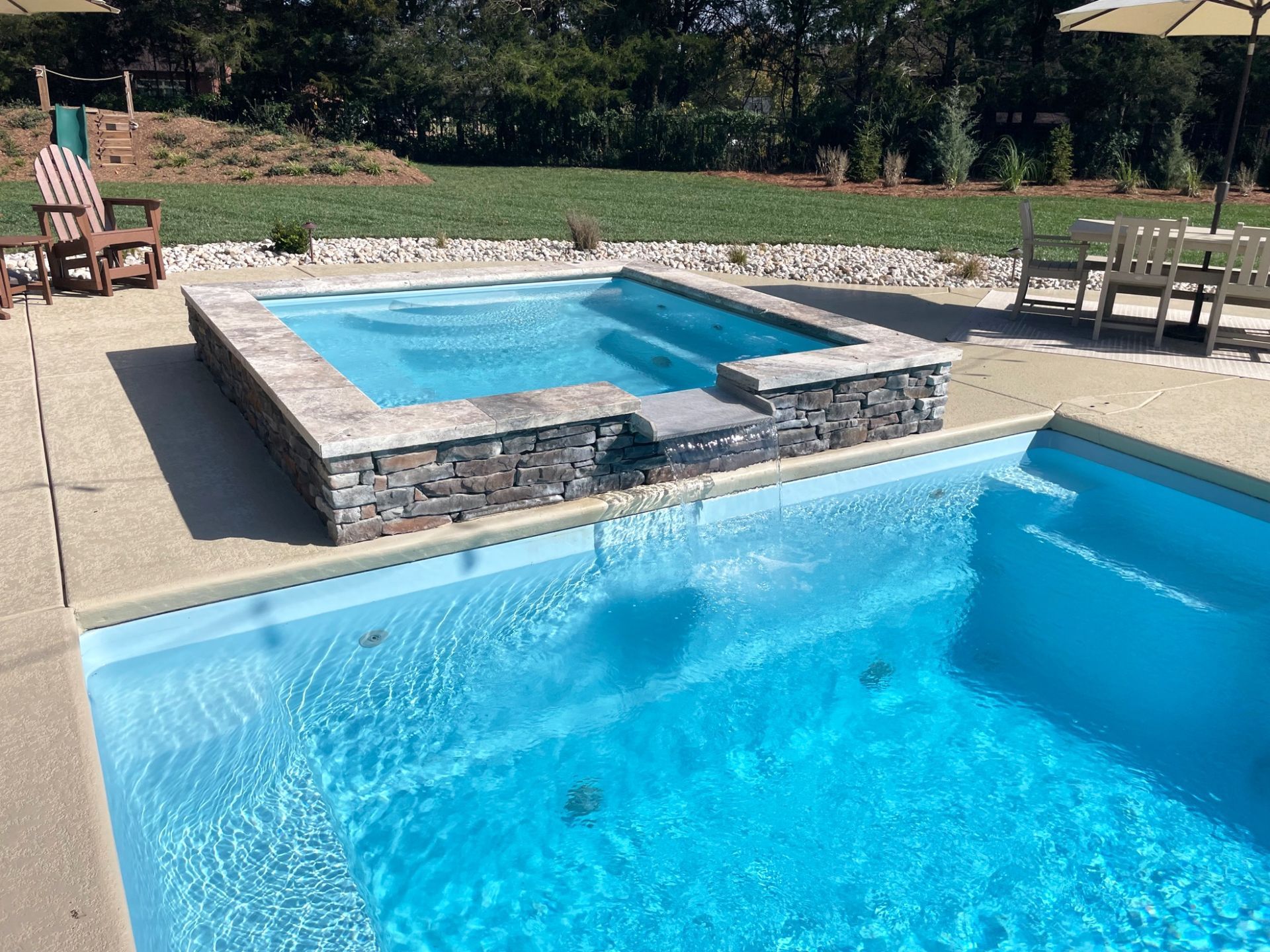 Lounge area with reclining chairs around Grace pool and spa in Murfreesboro TN