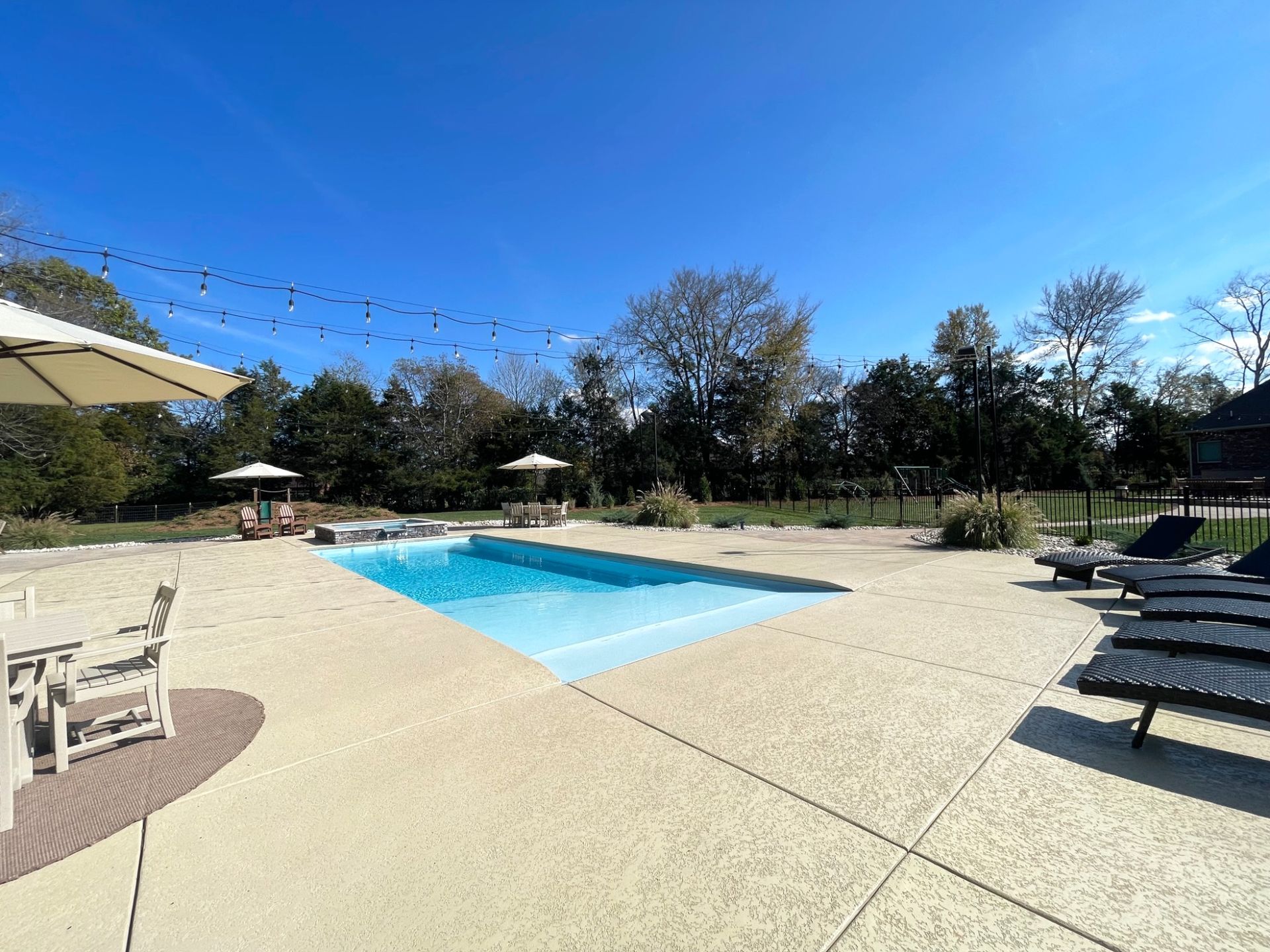 Side view of Grace beach entry pool showing spa and surrounding amenities in Murfreesboro TN