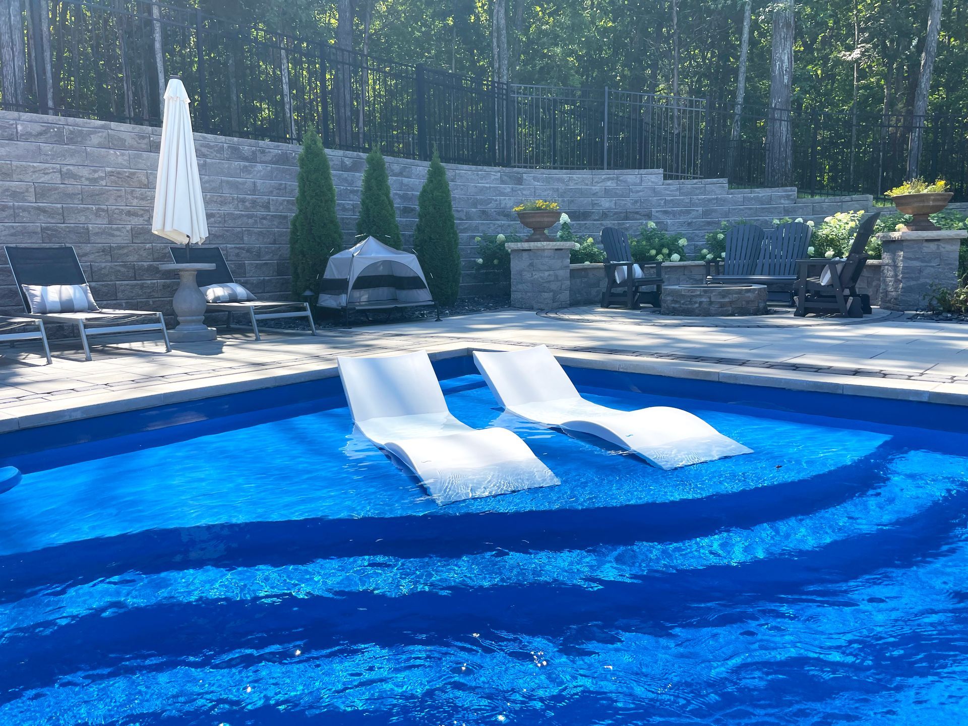 Relaxing tanning ledge with in-pool loungers on Aspen fiberglass pool by Majestic Swim in Murfreesboro, TN.