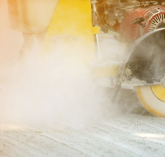 Construction Vehicle Spraying Dust Over a Gravel Road — Restore All Qld in Fraser Coast, QLD