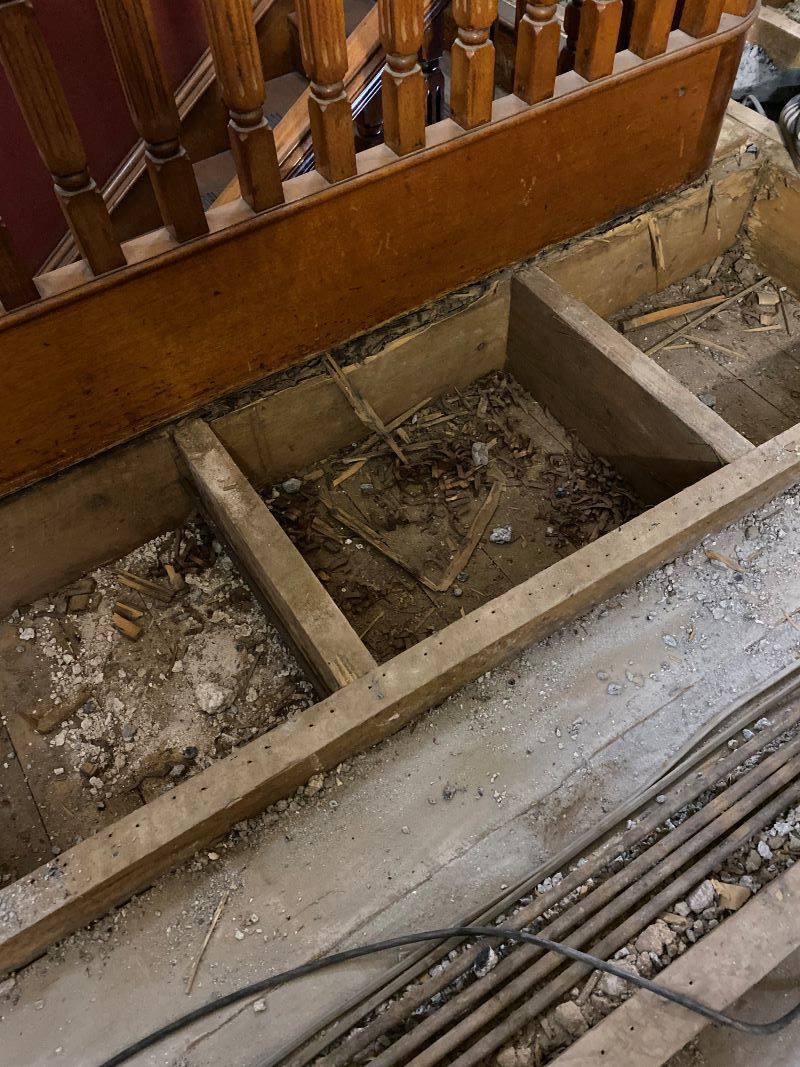 A Wooden Staircase With a Concrete Floor Underneath It — Restore All Qld in Fraser Coast, QLD