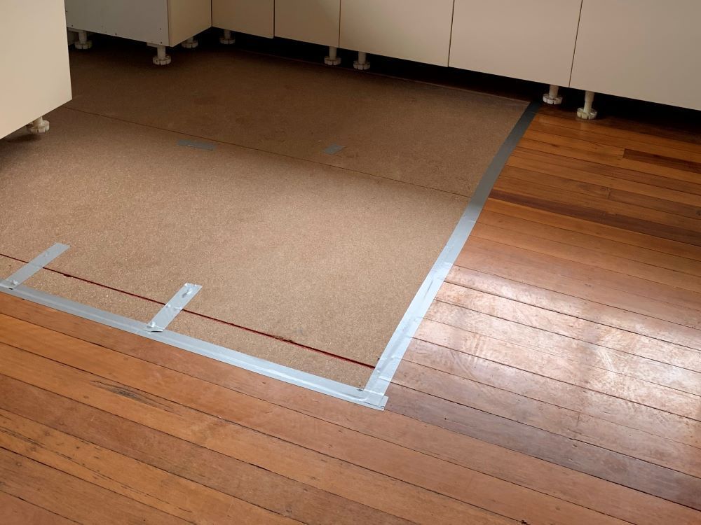 A Wooden Floor With a Carpeted Area in the Middle — Restore All Qld in South Burnett, QLD

