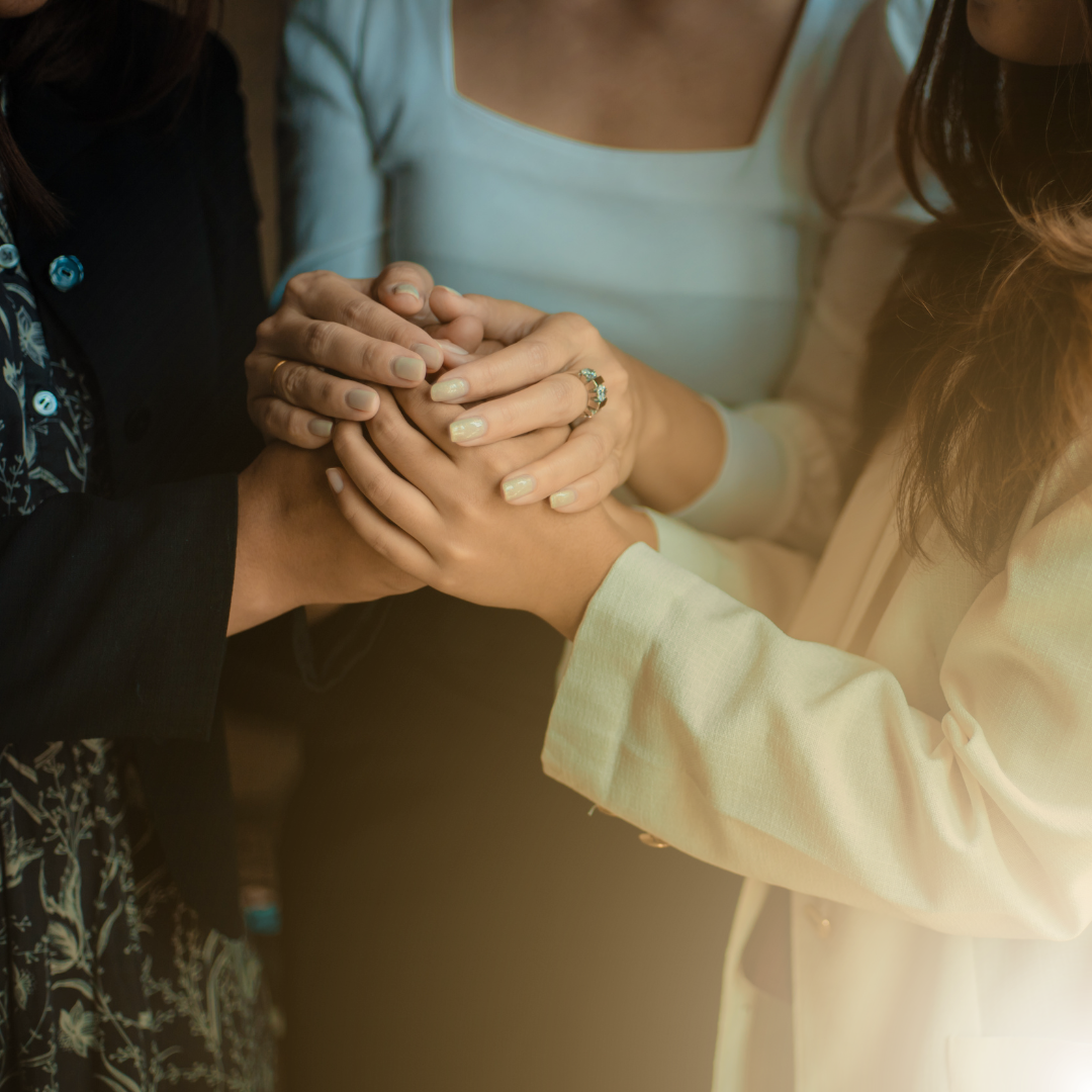 Three people holding hands together