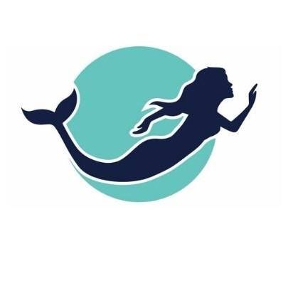 A silhouette of a mermaid swimming in the ocean.