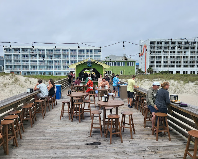 There is a wooden walkway leading to the beach.