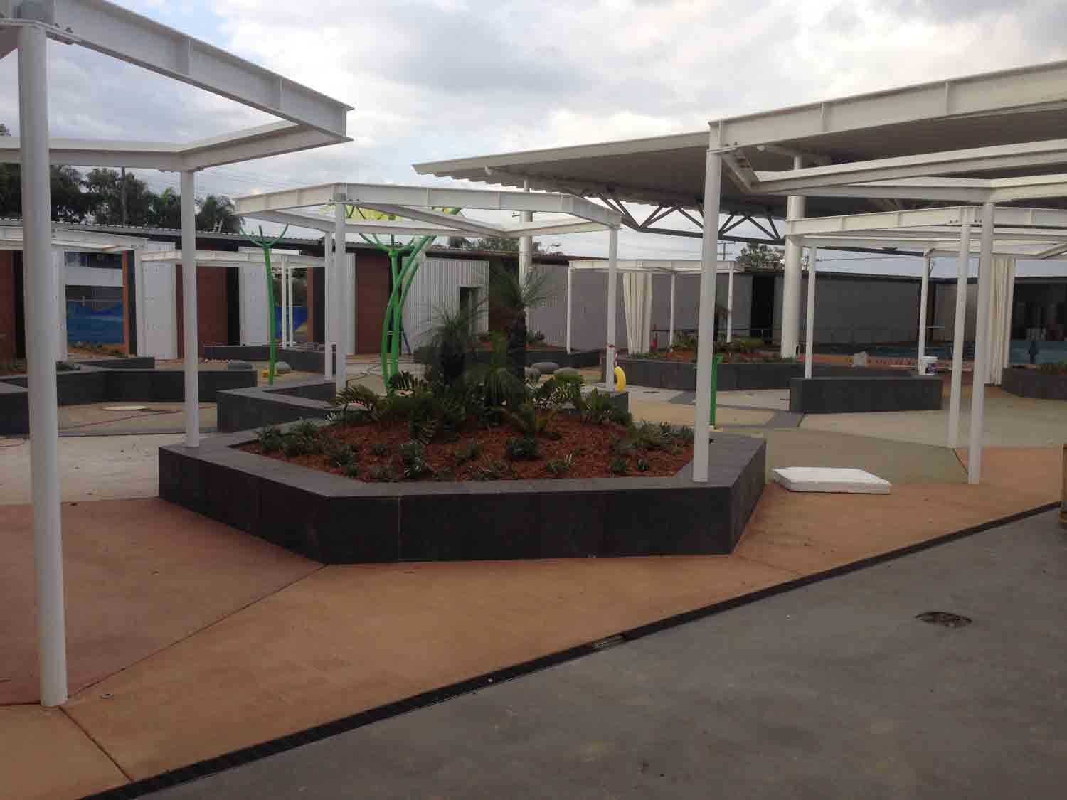 Outdoor Plaza with White-Framed Canopies — Wieland Concreting in Rockhampton, QLD
