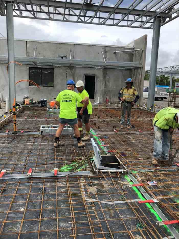 Construction Workers on Site Laying Rebar and Conduit — Wieland Concreting in Rockhampton, QLD