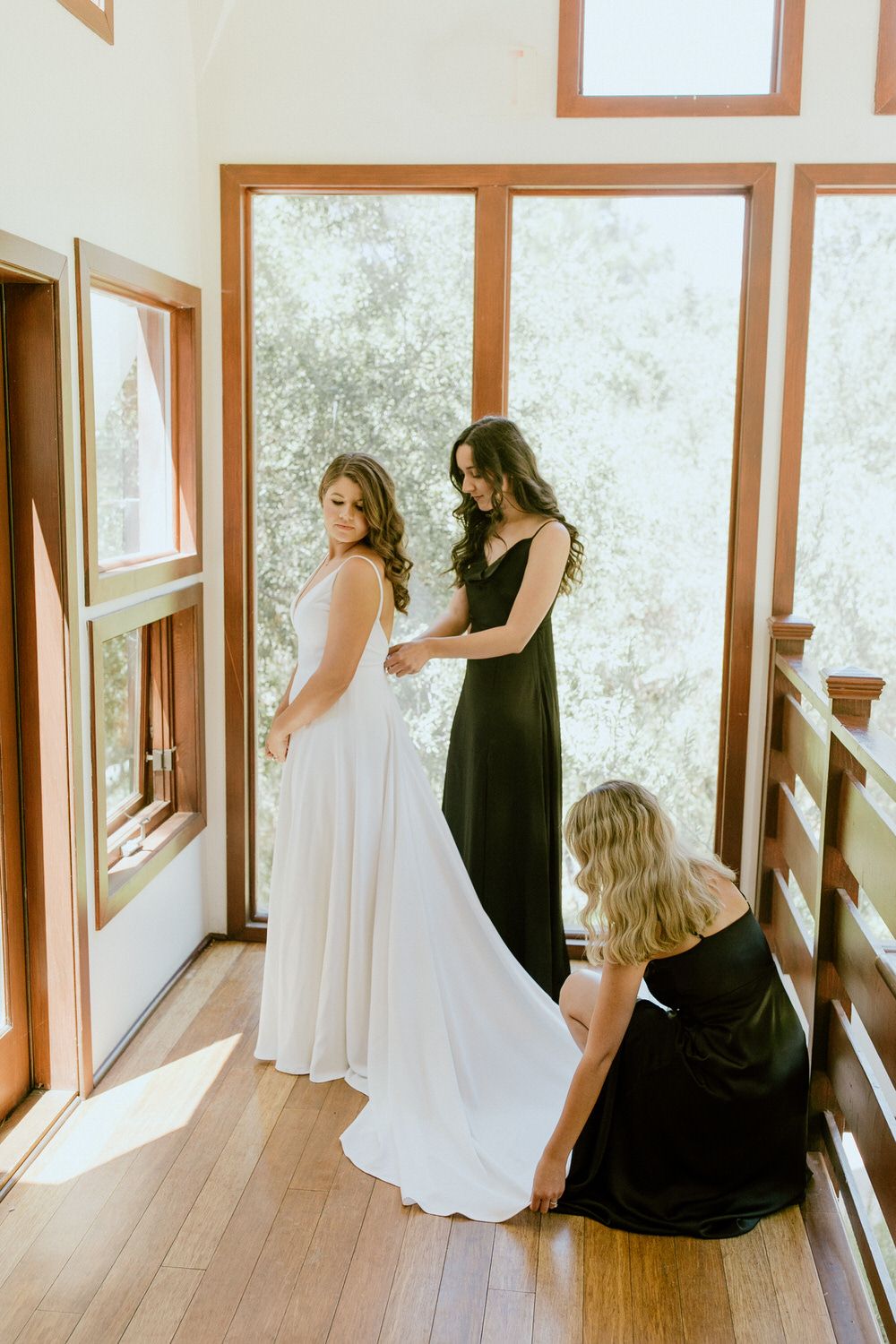 A bride is getting ready for her wedding with her bridesmaids.
