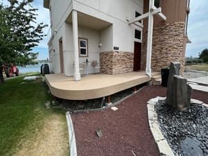 A large house with a large deck in front of it.