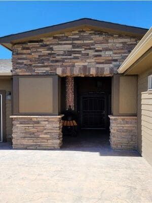 The front of a house with a stone facade