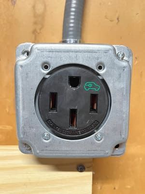 A close up of a electrical outlet on a wall.