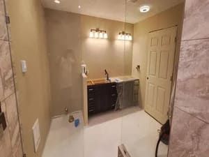 A bathroom with a walk in shower , sink , and mirror.