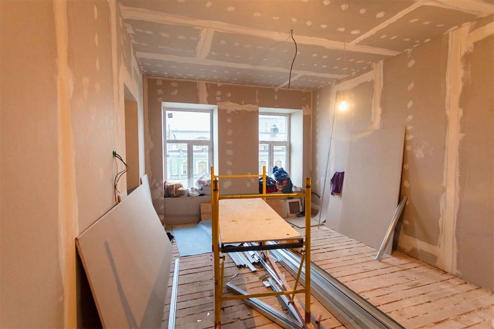A room is being remodeled with drywall and a scaffolding.
