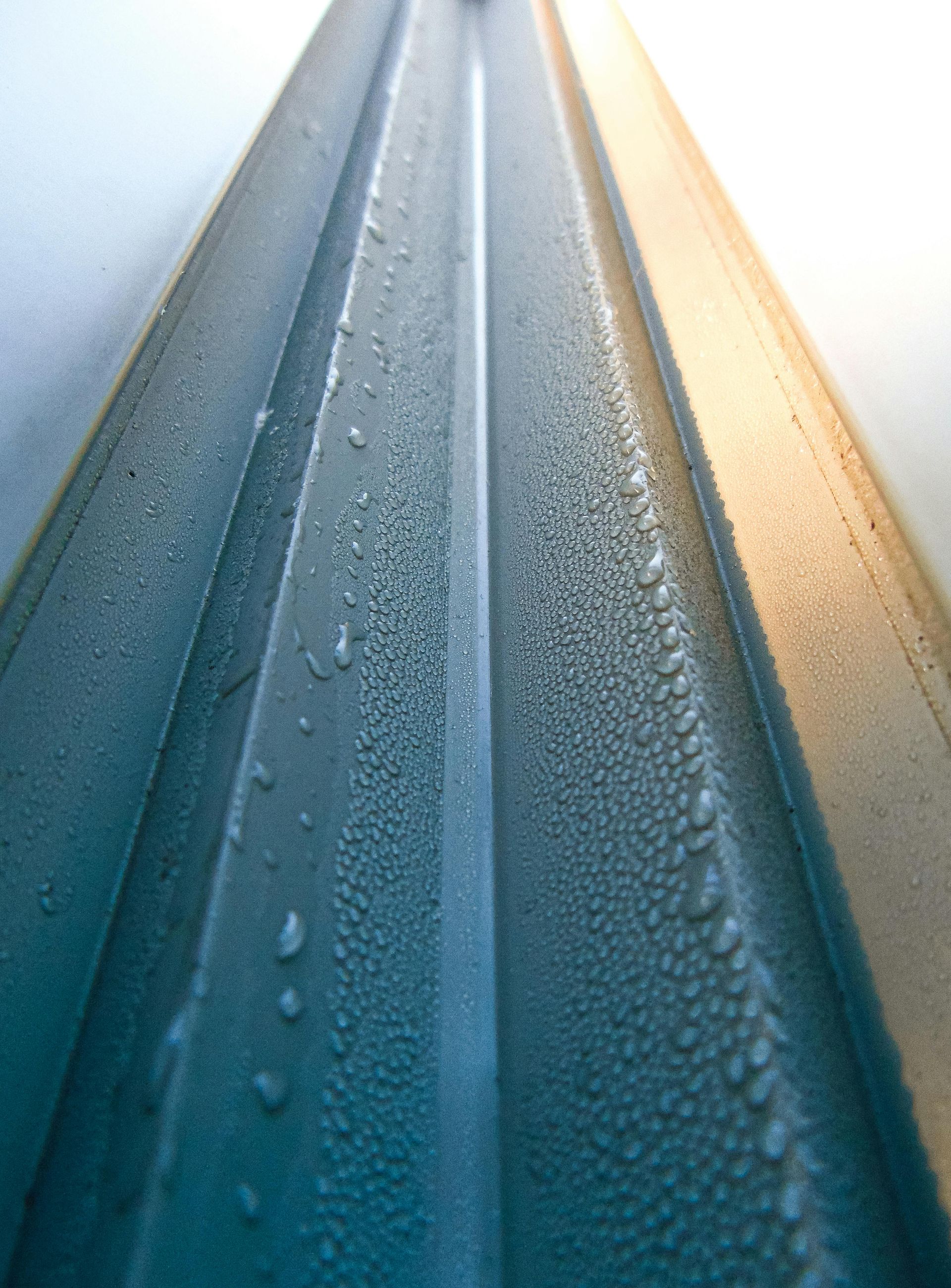 A close up of a road with water drops on it.
