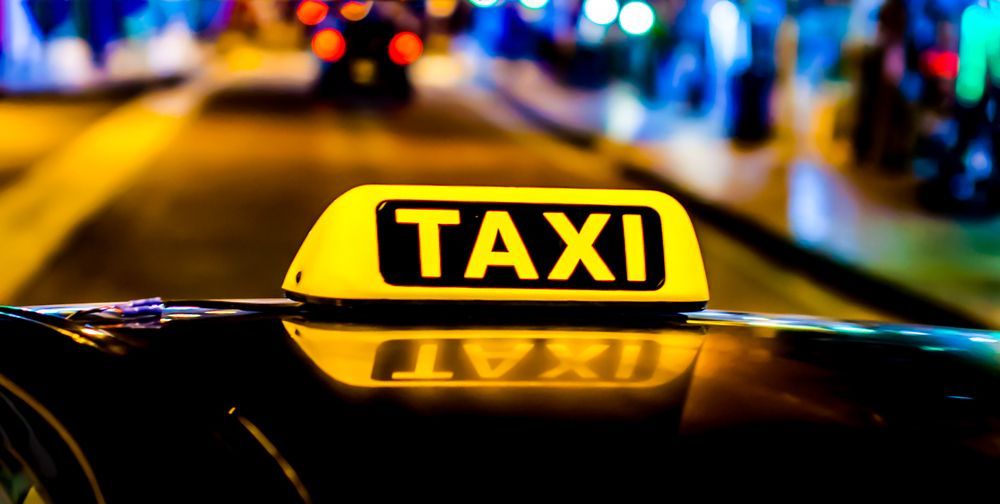 Yellow Taxi Roof Light with The Word Taxi Illuminated, on A Car — Precision Tuning in Cairns City, QLD