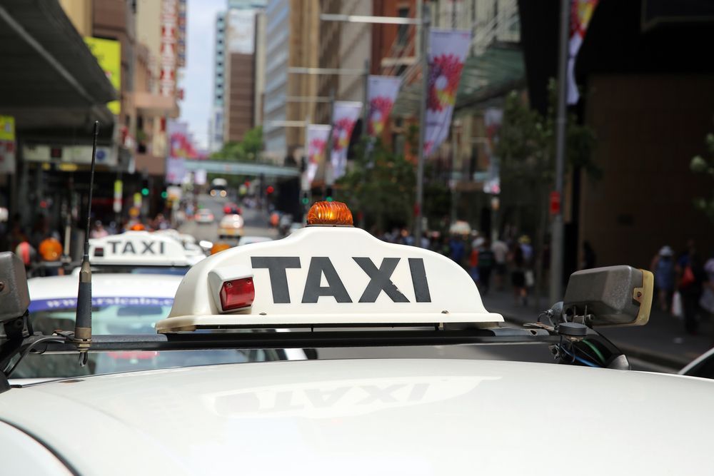 Taxi Cab in a City Street, With a Large White Taxi Sign — Precision Tuning in Trinity Beach, QLD