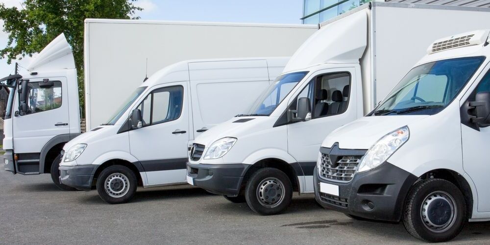 Four White Delivery Fleets Parked in A Row — Precision Tuning in Bungalow, QLD