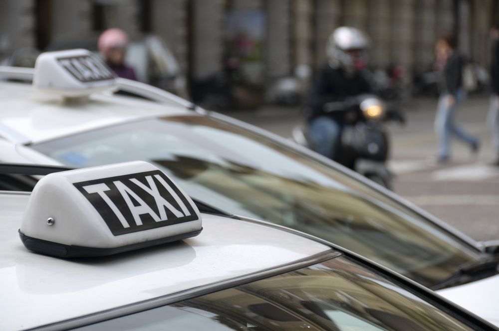 Close-up of a White Taxi Roof Sign on a Car in a City Street — Precision Tuning in Redlynch, QLD