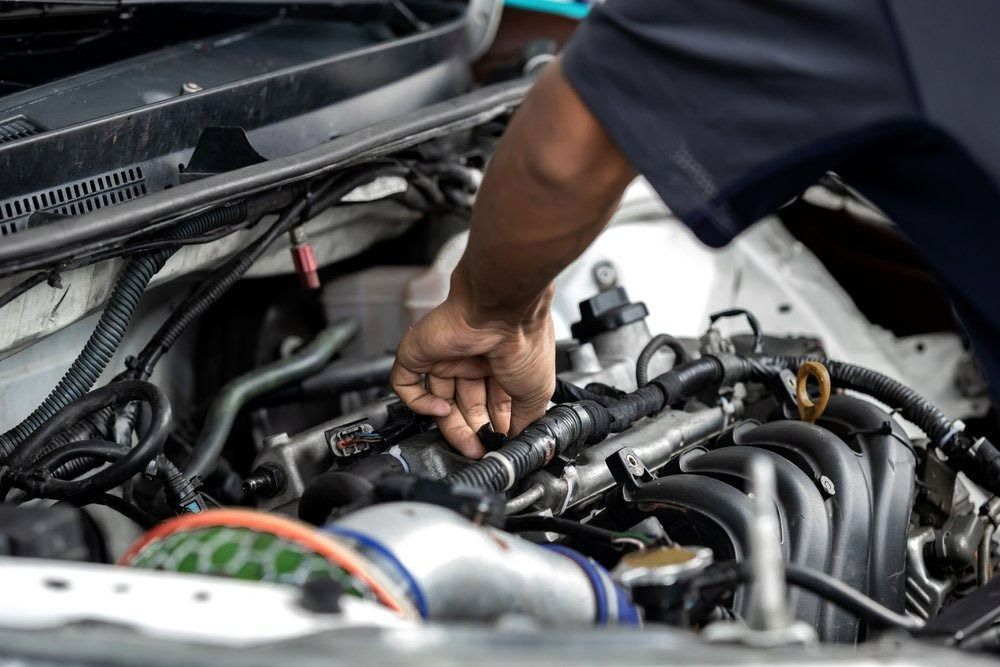Person Working on A Car Engine, Inspecting Parts — Precision Tuning in Bungalow, QLD