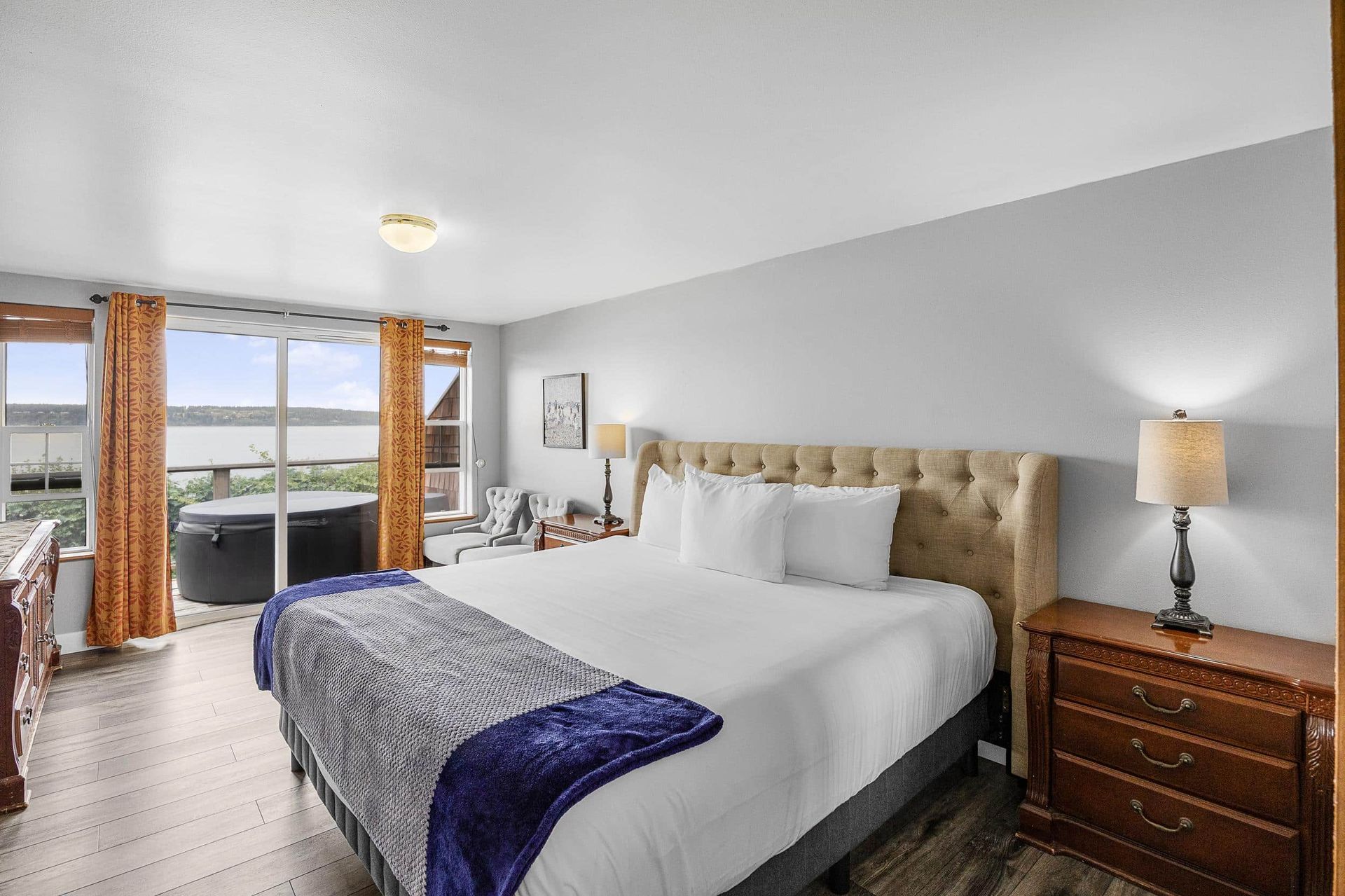 A four poster bed in a hotel room with a view of the ocean
