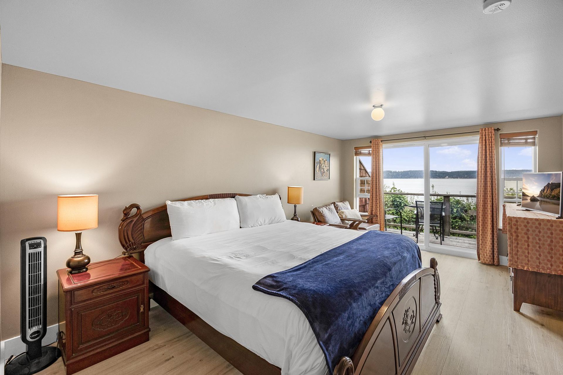A hotel room with a large bed and a large window