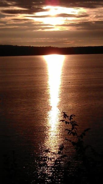 The sun is setting over a body of water