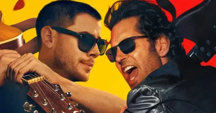 Dois homens de óculos escuros rindo enquanto tocam violão contra um fundo vermelho e amarelo vibrante.