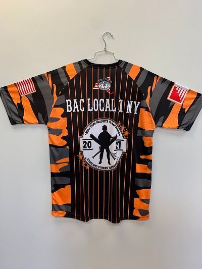 Back of a baseball jersey with orange and black camouflage,