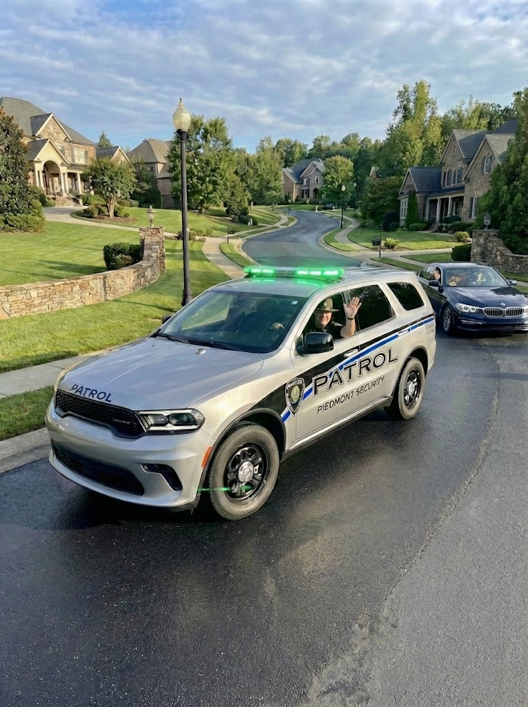 White police SUV driving on a suburban street in front of houses and trees