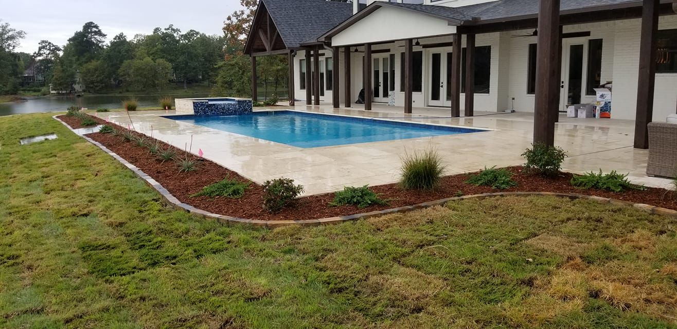 There is a swimming pool in the backyard of a house in Texarkana, TX.