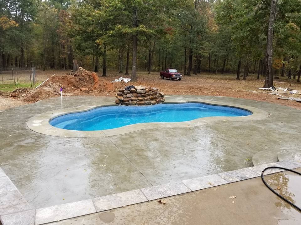 A swimming pool is being built in the backyard of a house in Texarkana, TX.
