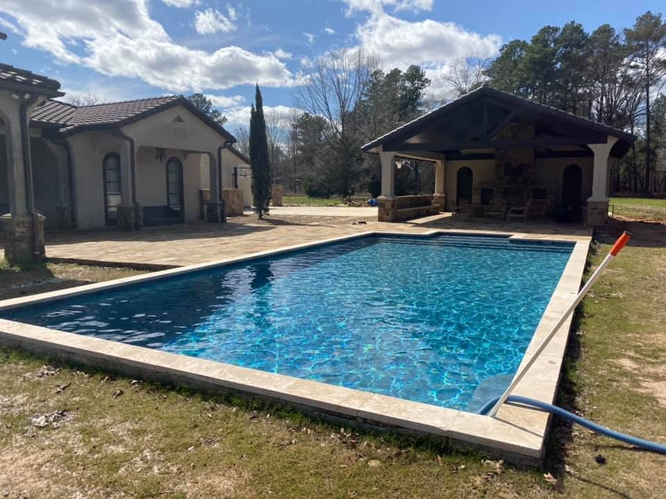 A swimming pool is being built in the backyard of a house in Texarkana, TX.