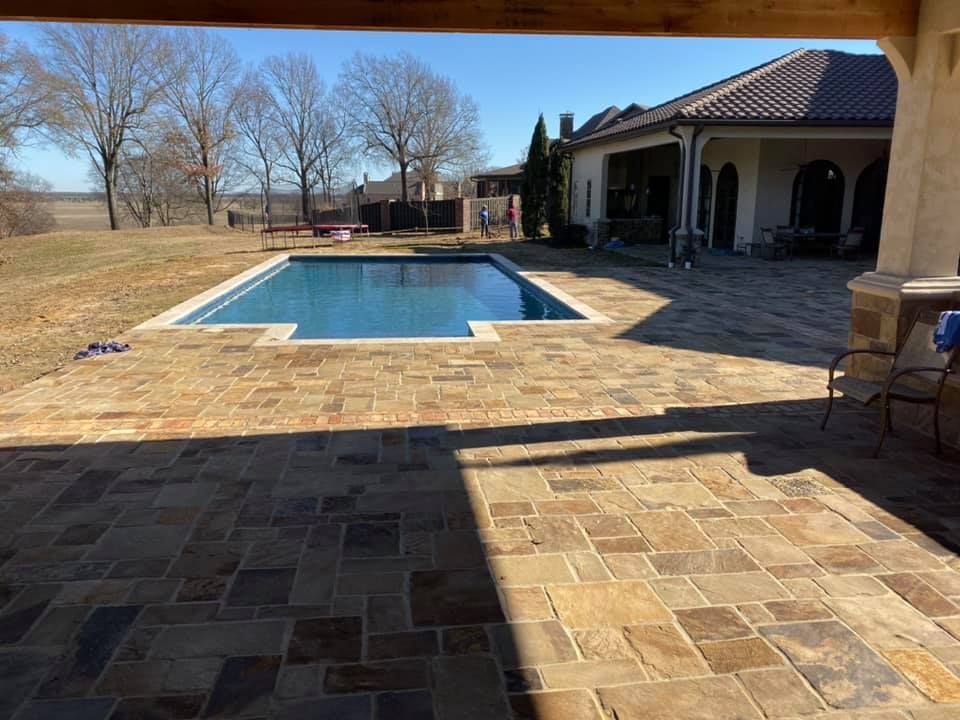 There is a large swimming pool in the backyard of a house in Texarkana, TX