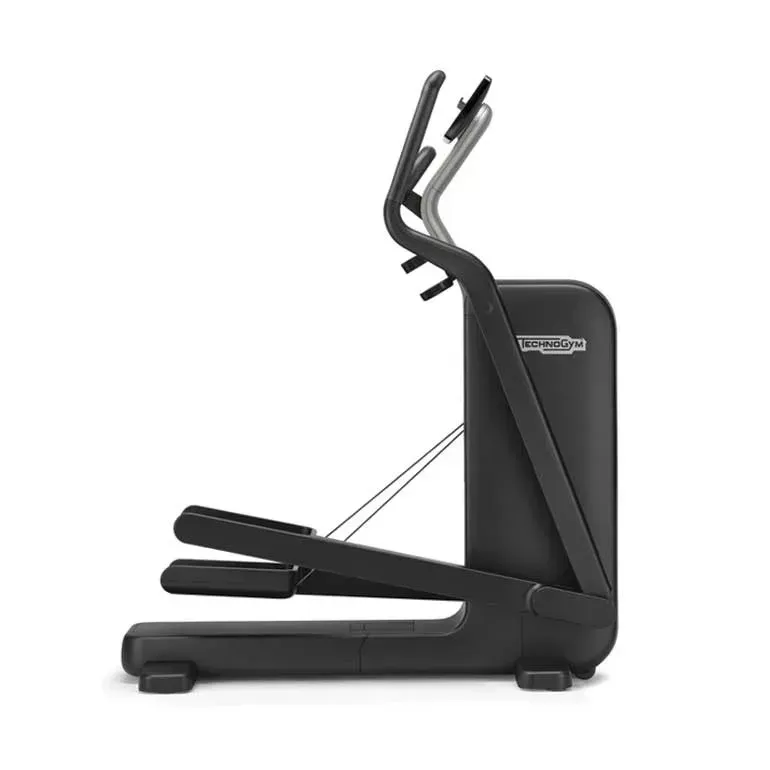 A side view of a black Technogym elliptical trainer on a white background.