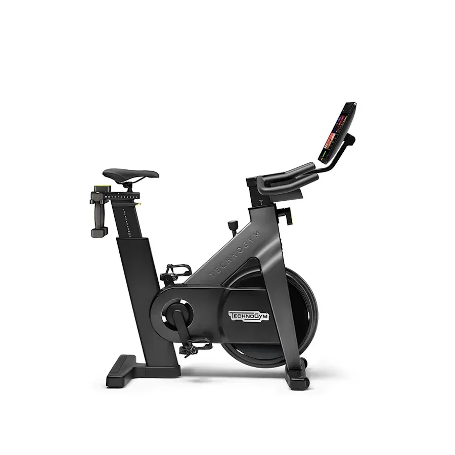 A charcoal gray Technogym stationary exercise bike set against a white background.