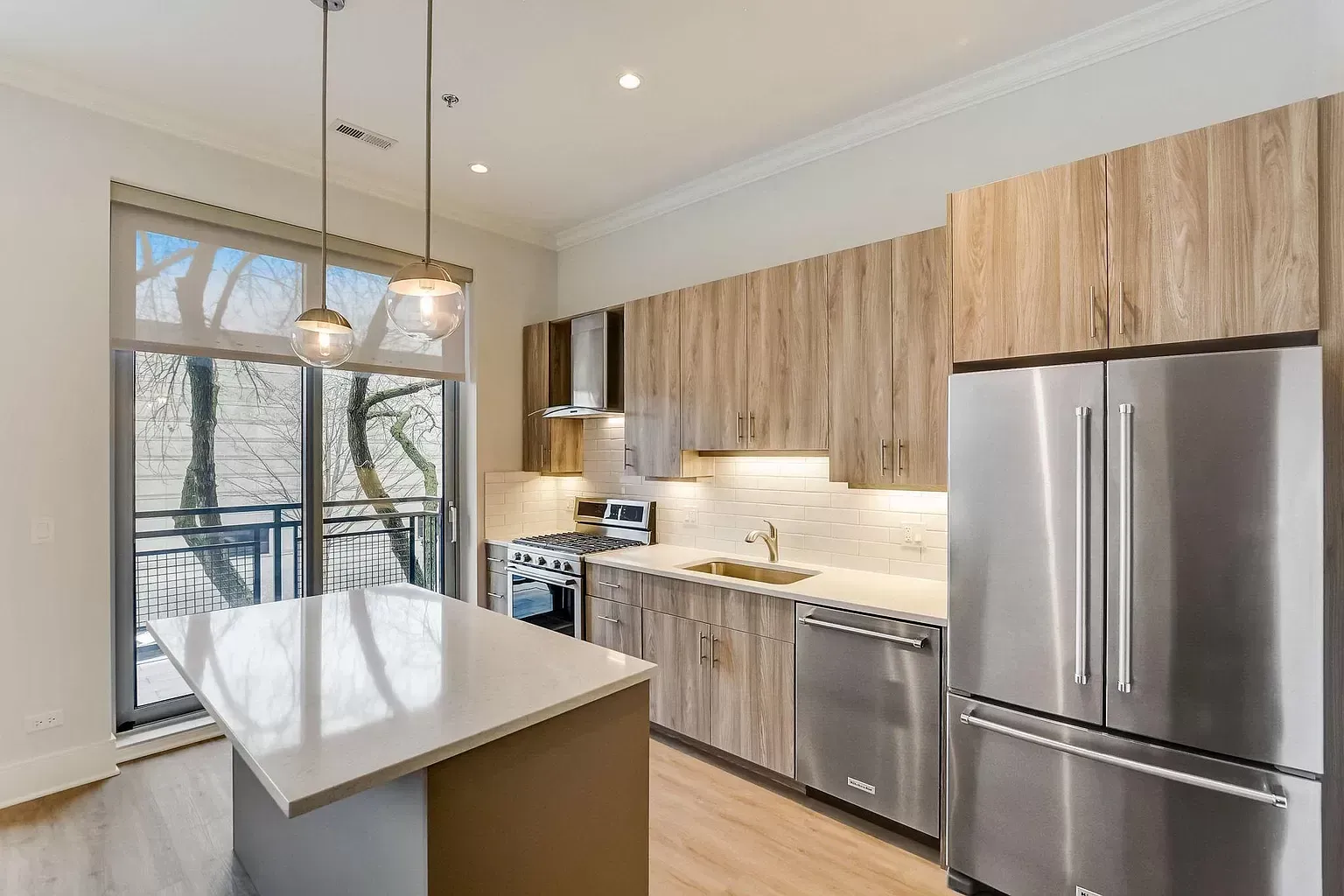 a kitchen with stainless steel appliances and wooden cabinets