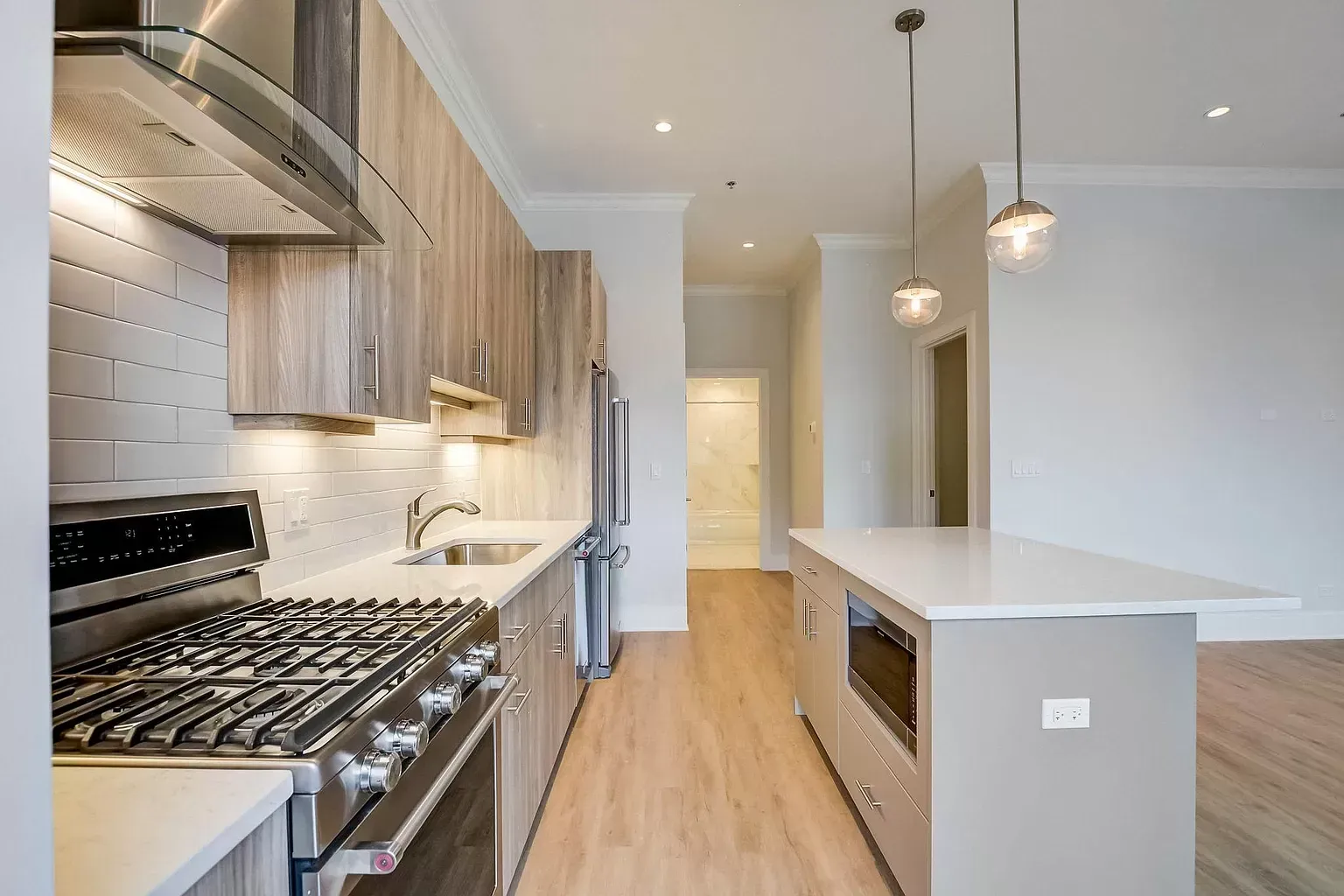 a kitchen with stainless steel appliances and wooden cabinets
