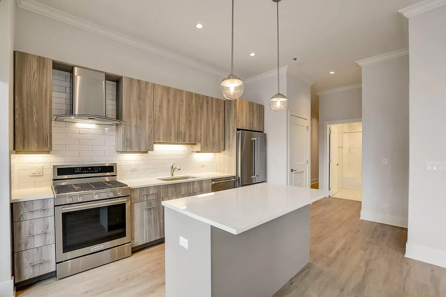a kitchen with stainless steel appliances and wooden cabinets .
