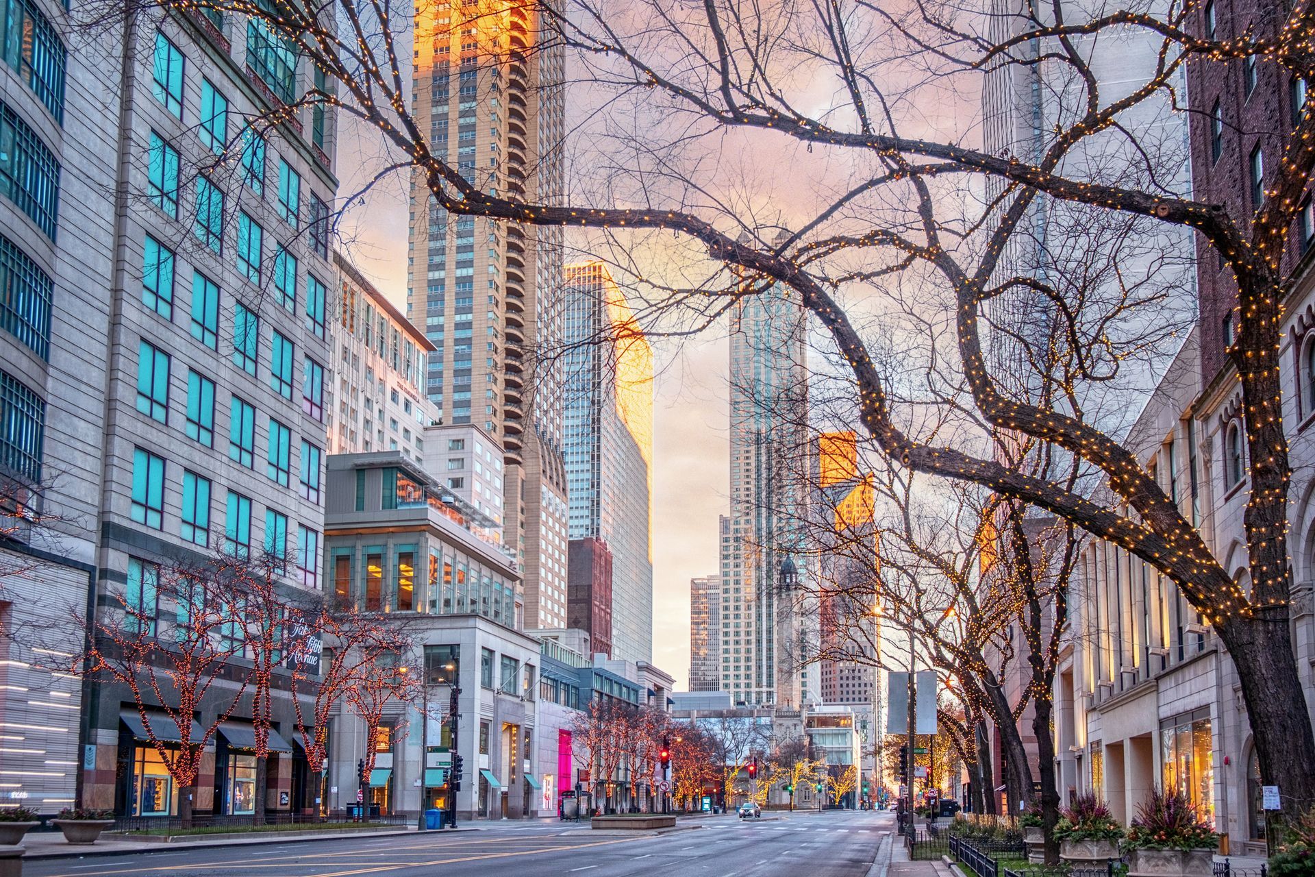 a city street with a lot of tall buildings and trees .