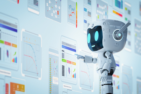 A robot is standing in front of a wall of charts and graphs.