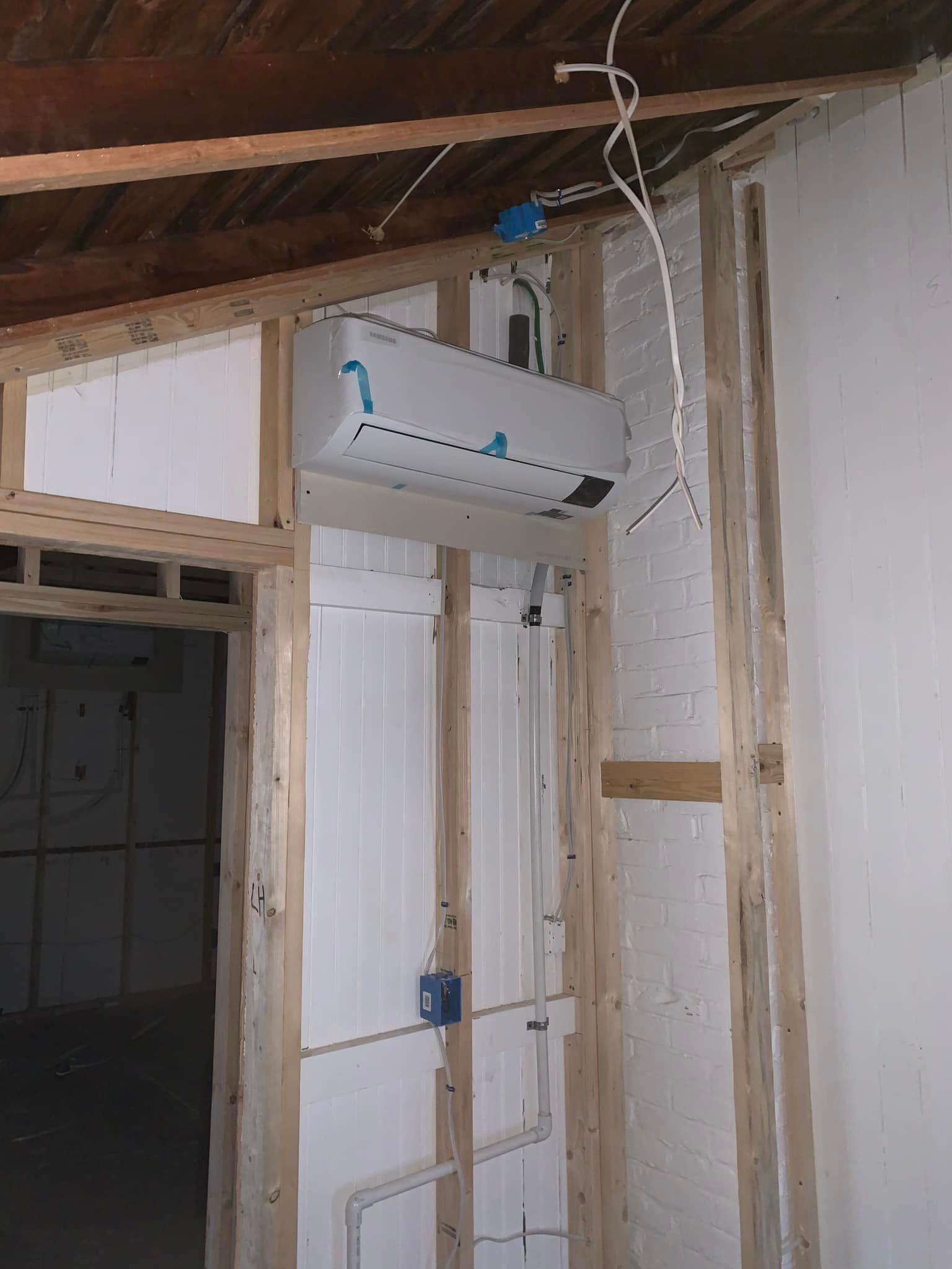 An air conditioner is hanging from the ceiling in a room.