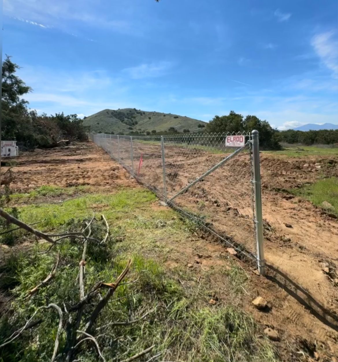 A Chain Link Fence Is Surrounding a Dirt Field — Riverside, CA — Elrod Fence Co